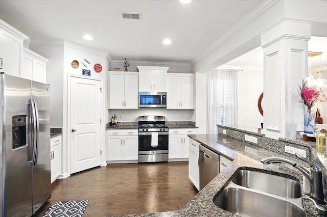 2324 Town Woods Rd, Charleston, SC 29414 - kitchen featuring appliances with stainless steel finishes, a sink, crown molding, dark wood-style flooring, and white cabinetry