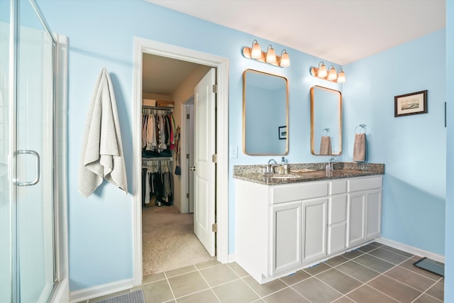 2324 Town Woods Rd, Charleston, SC 29414 - full bath with a shower stall, double vanity, tile patterned flooring, a spacious closet, and baseboards
