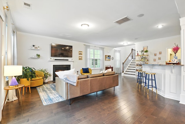 2324 Town Woods Rd, Charleston, SC 29414 - living room with a lit fireplace, ornamental molding, dark wood-type flooring, and stairway