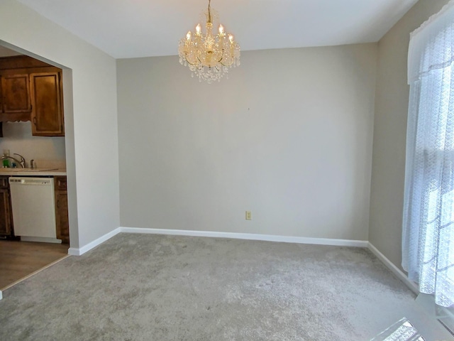 unfurnished dining area with an inviting chandelier, light colored carpet, and sink