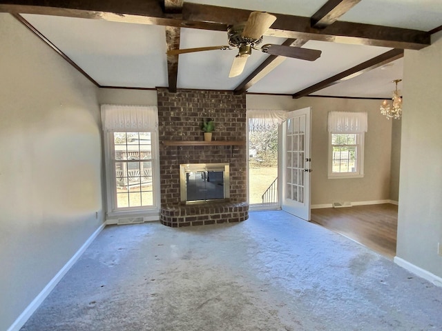 unfurnished living room with beam ceiling, a fireplace, a chandelier, and carpet