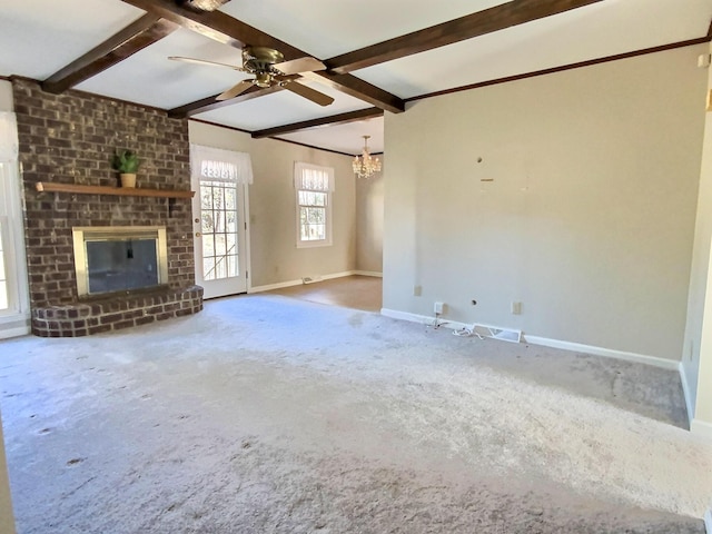 unfurnished living room featuring a brick fireplace, carpet flooring, ceiling fan with notable chandelier, and beam ceiling