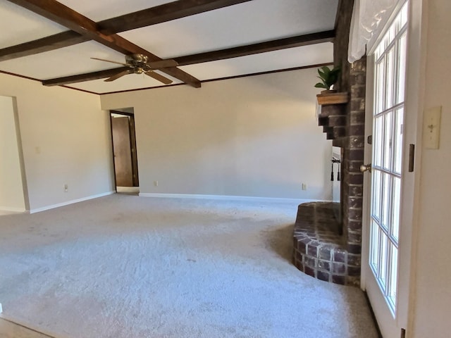 interior space featuring ceiling fan, beam ceiling, and light carpet