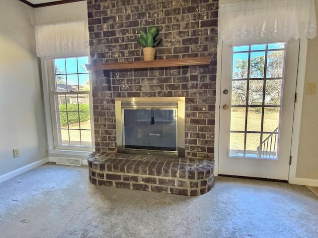 unfurnished living room with carpet and a brick fireplace