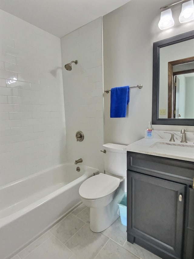 full bathroom featuring tiled shower / bath, vanity, toilet, and tile patterned flooring