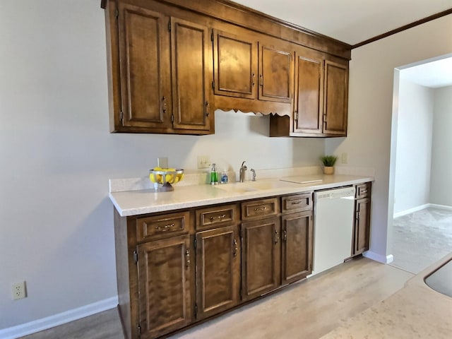 kitchen featuring dark brown cabinetry, sink, white dishwasher, and light hardwood / wood-style floors