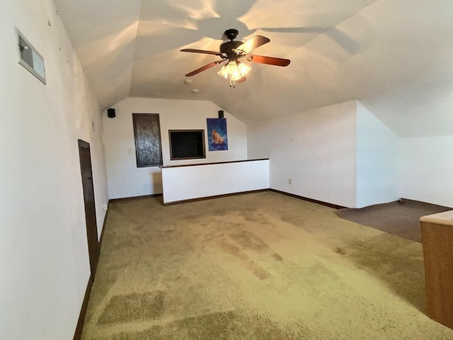 bonus room featuring lofted ceiling, carpet flooring, and ceiling fan