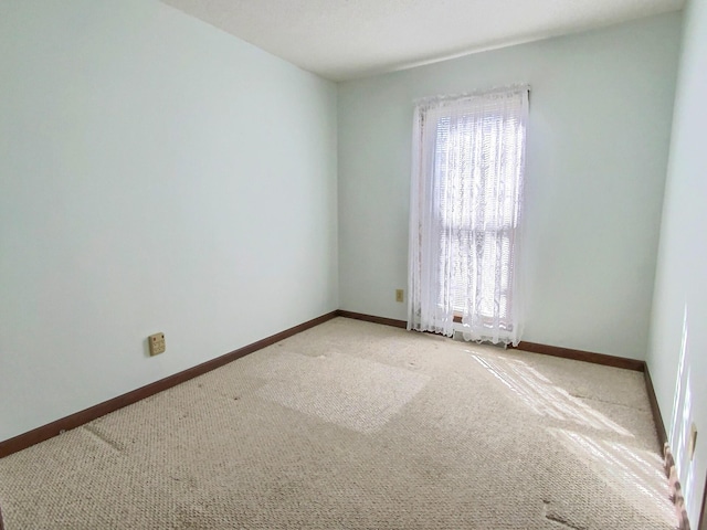 unfurnished room featuring light colored carpet