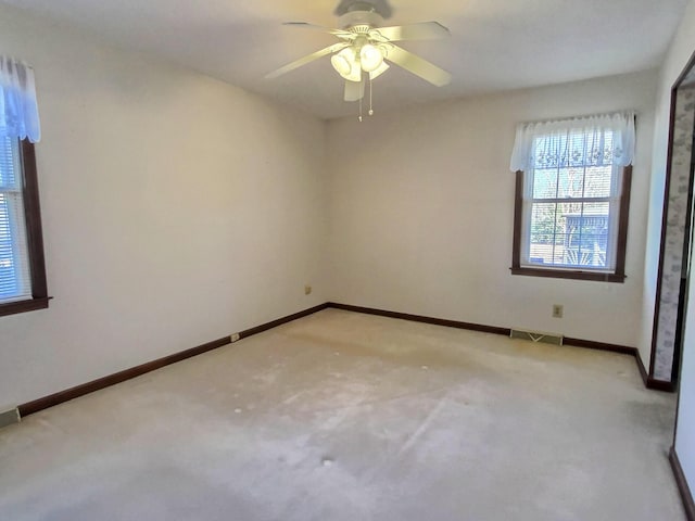 carpeted empty room featuring ceiling fan