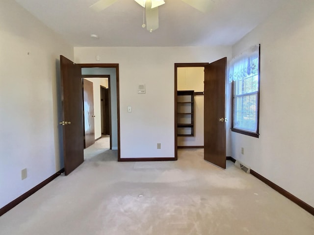 unfurnished bedroom featuring light colored carpet and ceiling fan