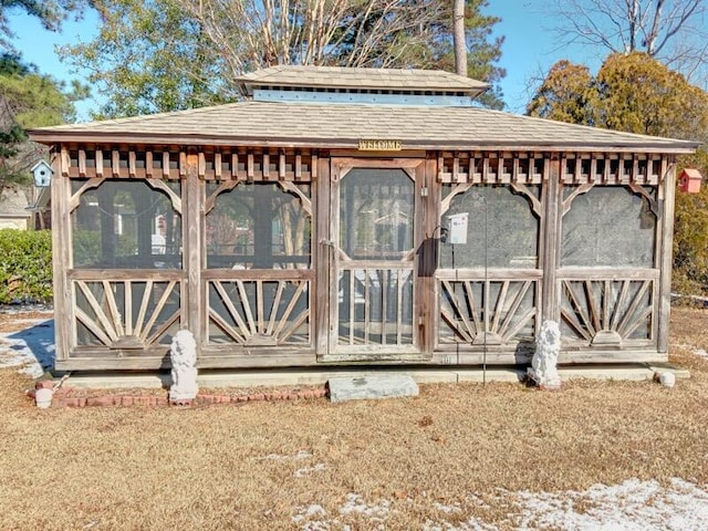 view of gate with an outdoor structure