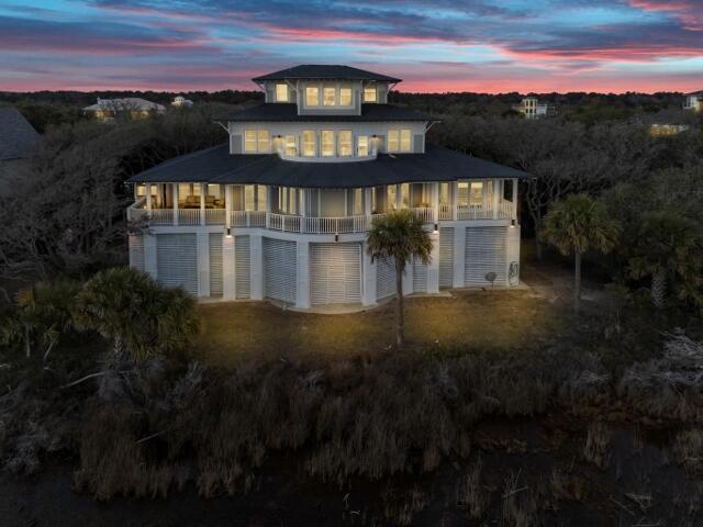 back house at dusk with a balcony