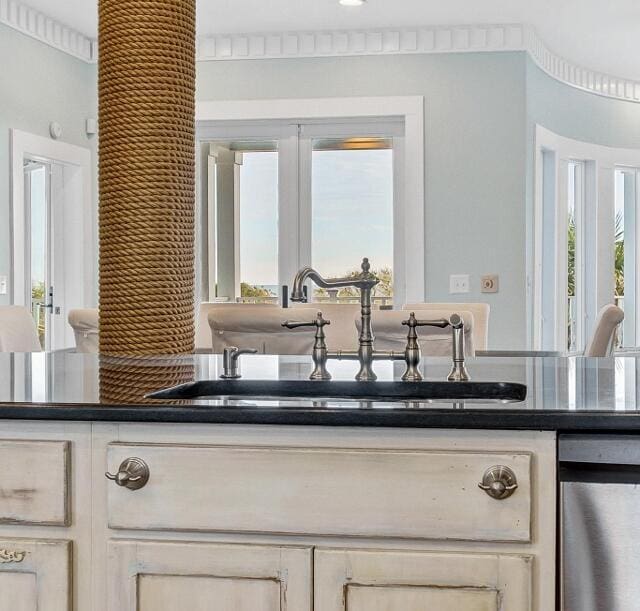 kitchen with crown molding, sink, and french doors