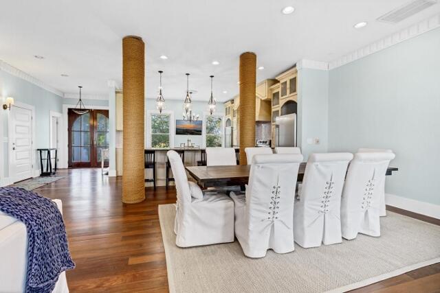 dining space with dark hardwood / wood-style floors and ornamental molding