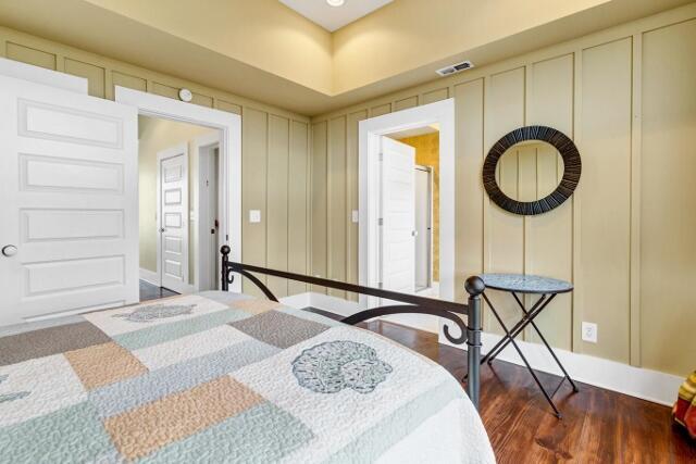 bedroom with dark hardwood / wood-style flooring