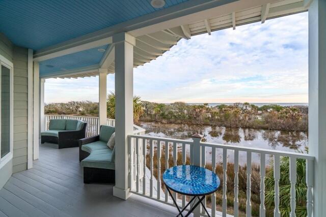 balcony featuring a water view and an outdoor hangout area