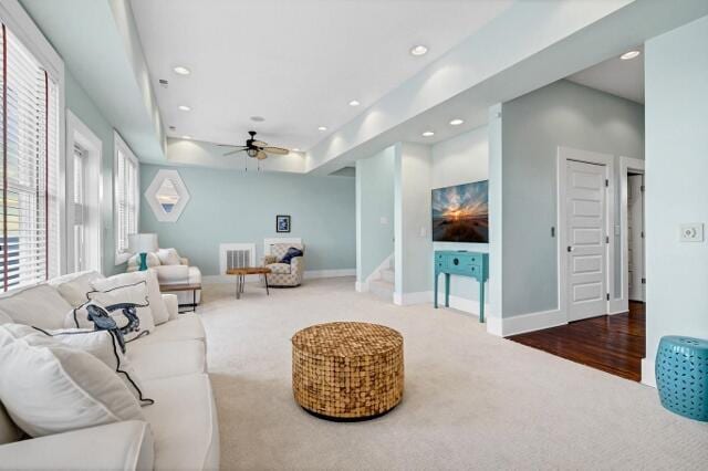 living room featuring carpet and ceiling fan