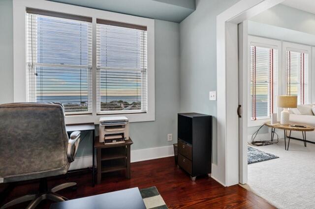 office area featuring dark hardwood / wood-style floors and a healthy amount of sunlight