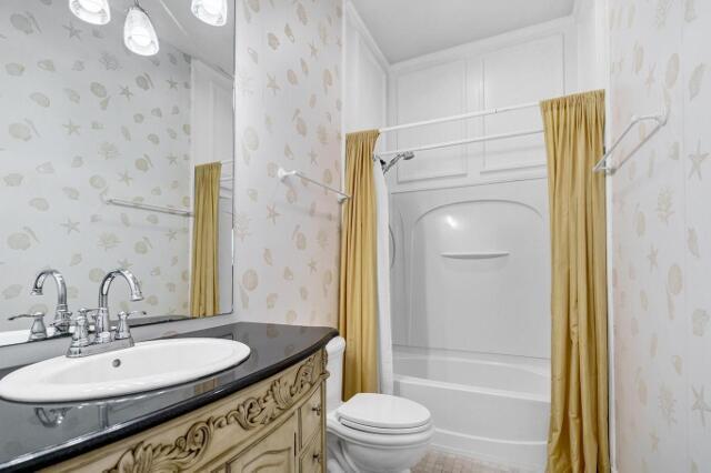 full bathroom featuring tile patterned floors, vanity, toilet, and shower / tub combo