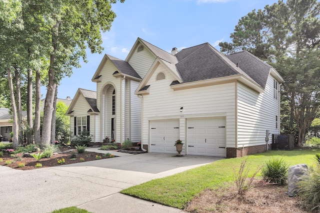 1311 Royal Links Dr, Mount Pleasant, SC 29466 - traditional-style home with concrete driveway, a shingled roof, a garage, and a front lawn