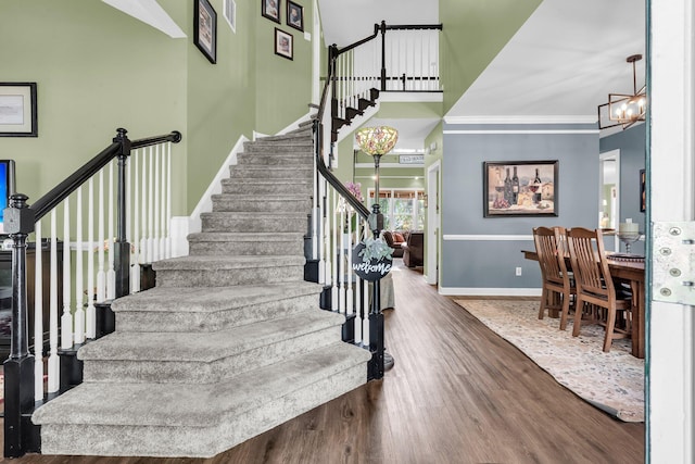 1311 Royal Links Dr, Mount Pleasant, SC 29466 - stairs with wood finished floors, ornamental molding, and a chandelier