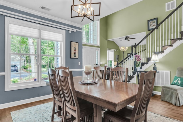 1311 Royal Links Dr, Mount Pleasant, SC 29466 - dining room with a chandelier, stairway, wood finished floors, and crown molding