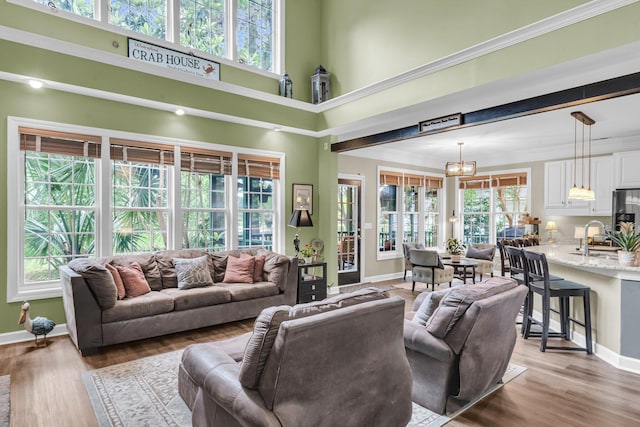 1311 Royal Links Dr, Mount Pleasant, SC 29466 - living room featuring healthy amount of natural light, wood finished floors, and a towering ceiling