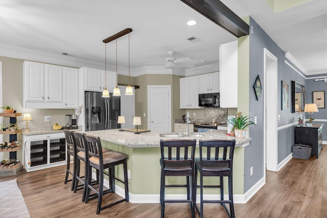 1311 Royal Links Dr, Mount Pleasant, SC 29466 - kitchen featuring black microwave, stainless steel refrigerator with ice dispenser, ceiling fan, white cabinets, and crown molding