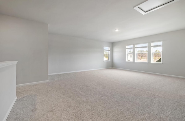 carpeted empty room featuring recessed lighting and baseboards