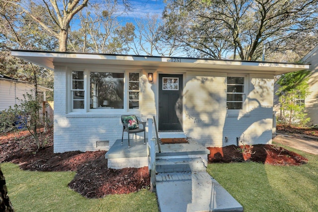 bungalow-style house featuring brick siding and crawl space