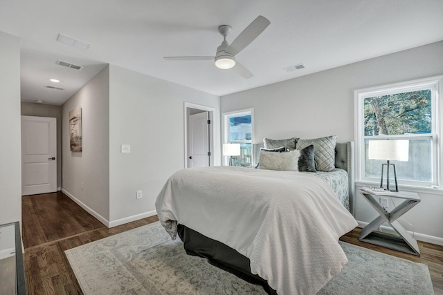 bedroom featuring visible vents, baseboards, and wood finished floors