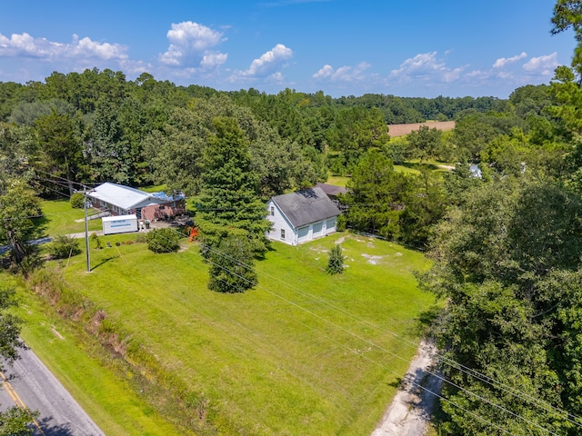 birds eye view of property featuring a wooded view