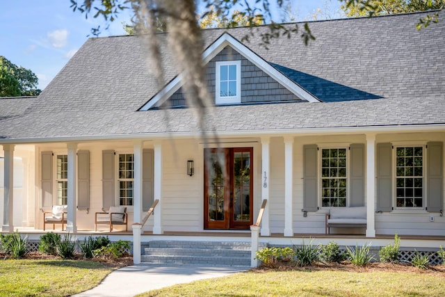 view of front facade featuring a porch, french doors, and roof with shingles