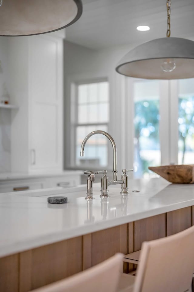 room details featuring white cabinetry and light countertops