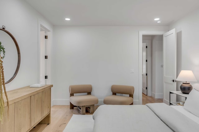 bedroom with light wood-type flooring, baseboards, and recessed lighting