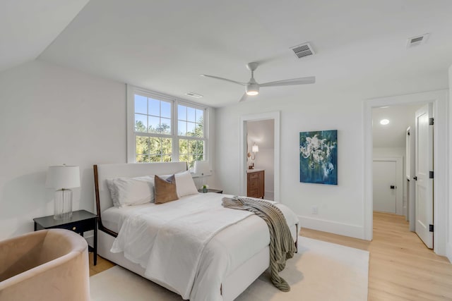 bedroom featuring ceiling fan, connected bathroom, light wood-style flooring, visible vents, and baseboards