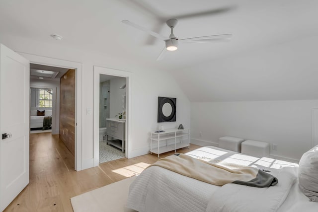 bedroom featuring attic access, baseboards, a ceiling fan, vaulted ceiling, and light wood-type flooring