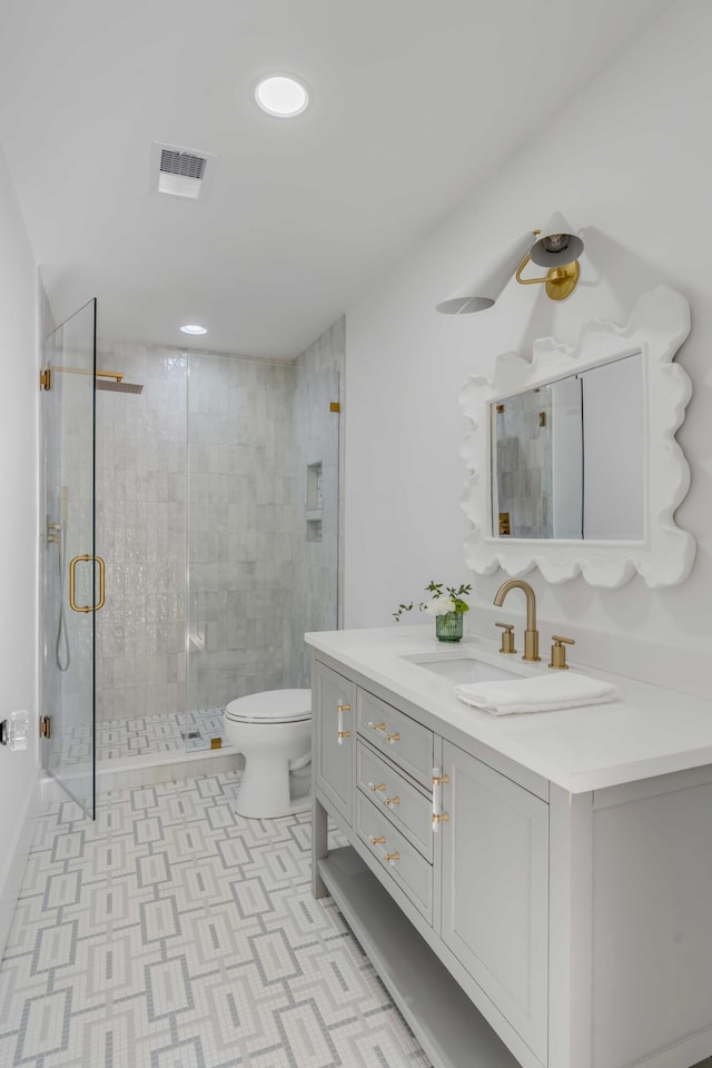 bathroom featuring a stall shower, visible vents, toilet, tile patterned floors, and vanity