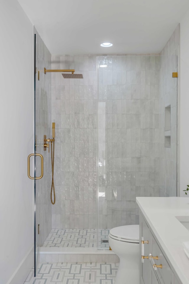 full bathroom featuring vanity, a shower stall, and toilet