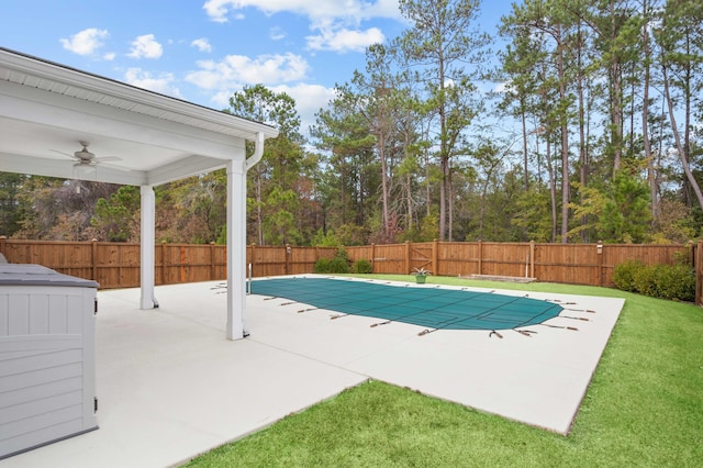 view of pool with a lawn, ceiling fan, and a patio area