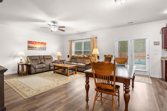 dining area featuring ceiling fan and dark wood-type flooring