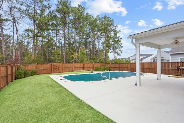 view of pool with ceiling fan, a yard, and a patio