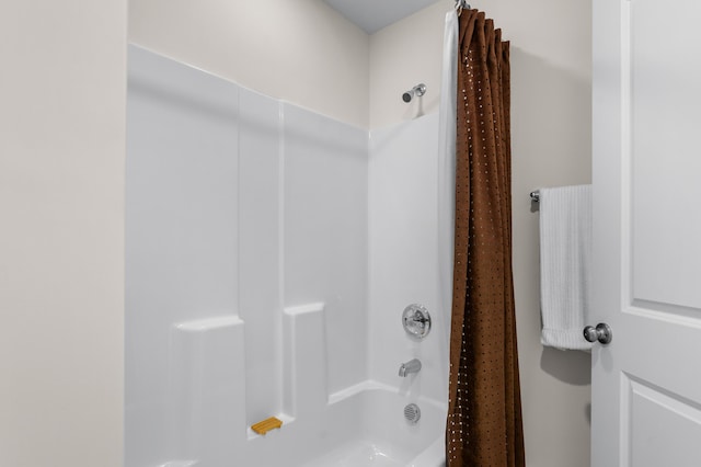 bathroom with shower / bath combination with curtain