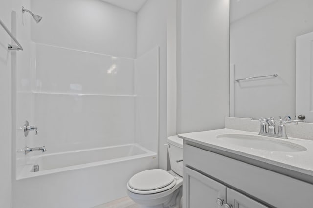 bathroom with vanity, shower / bathing tub combination, and toilet