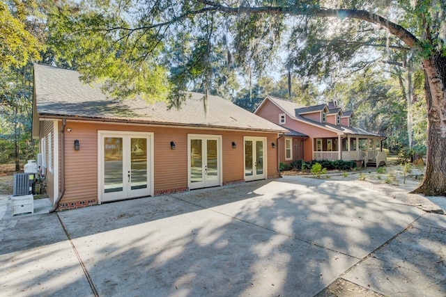 rear view of property with a patio, french doors, and central AC unit