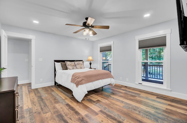 bedroom with ceiling fan and hardwood / wood-style flooring