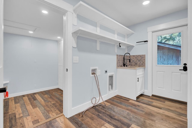 laundry area featuring hookup for a washing machine, hookup for an electric dryer, sink, cabinets, and dark hardwood / wood-style flooring