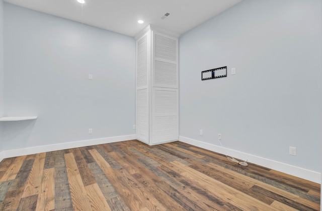 unfurnished room with hardwood / wood-style flooring