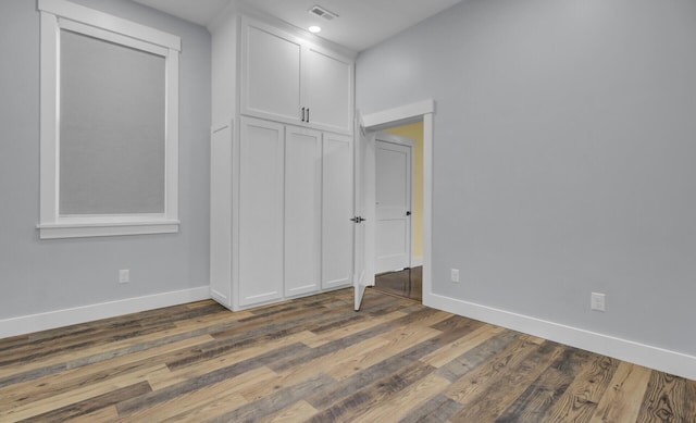 4429 Francis Younge Way, Hollywood, SC 29449 - unfurnished bedroom featuring visible vents, baseboards, and wood finished floors
