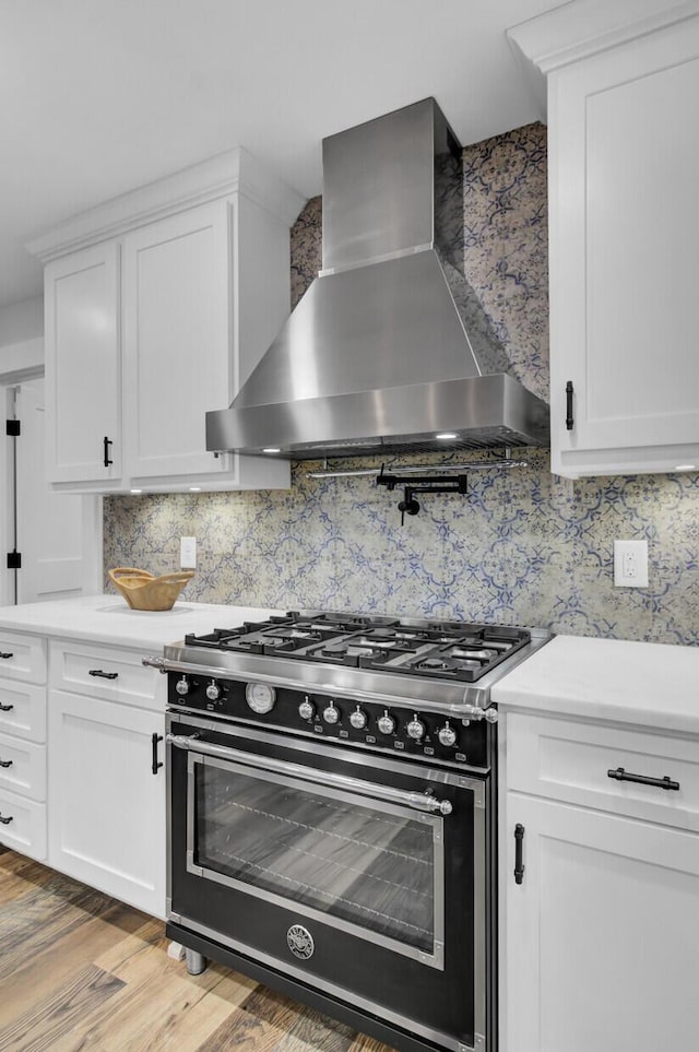 4429 Francis Younge Way, Hollywood, SC 29449 - kitchen with tasteful backsplash, gas stove, light countertops, light wood finished floors, and wall chimney exhaust hood